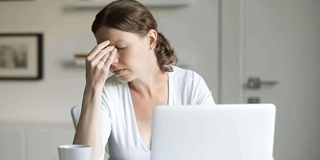 Woman suffering from headache that needs chiropractic for pain relief