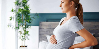 Pregnant woman experiencing discomfort needs chiropractic to help relieve pressure
