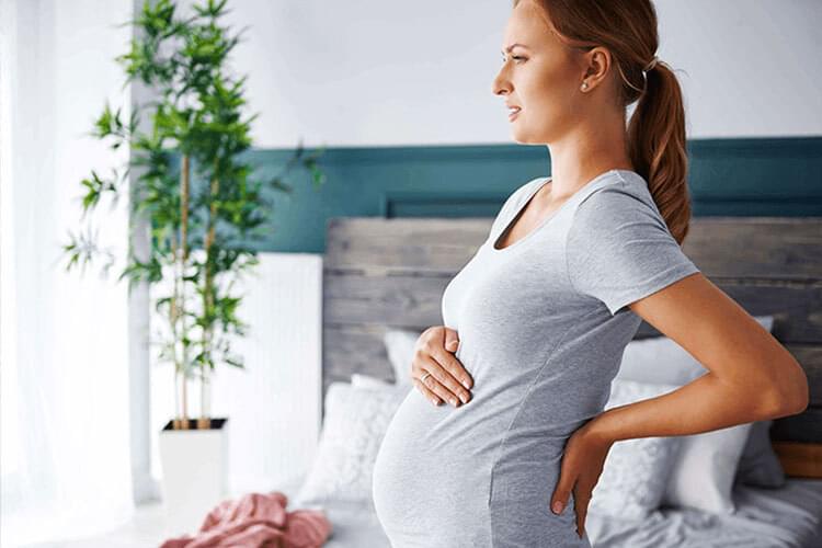 Pregnant woman experiencing discomfort from pregnancy seeking chiropractic care